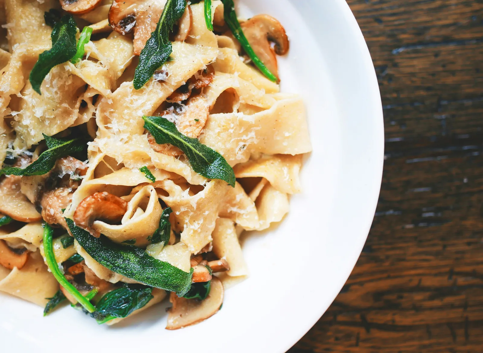 House-made tagliatelle pasta with truffle cream sauce and shaved Parmigiano